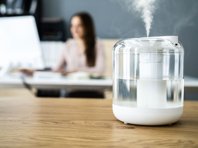 A clean, working humidifier sending cool mist throughout a room